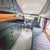 Komplettes Camper-Interieur in einem Land Rover Defender 110: Küchenschrank, Sitzbank und Querschrank