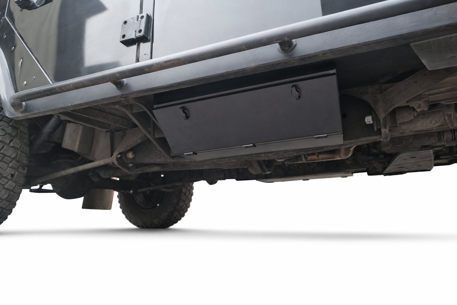 Chassis storage box mounted under the chassis of a Land Rover Defender, passenger side